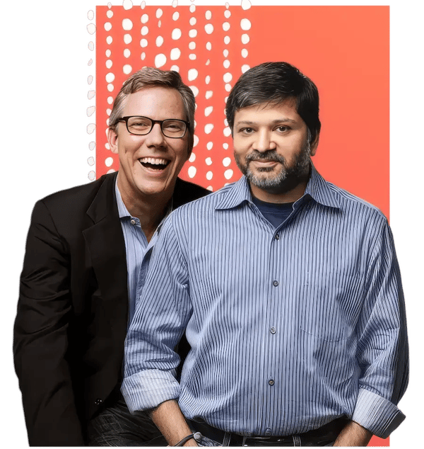 HubSpot co-founders Brian Halligan and Dharmesh Shah in a professional portrait against an orange background with dot pattern, representing the entrepreneurial vision behind the inbound marketing platform