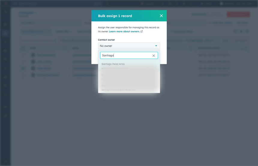 HubSpot CRM bulk assign modal showing contact owner dropdown with one user selected to assign ownership of a contact record.